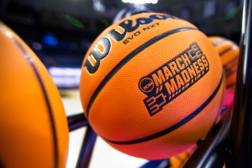 A basketball with a March Madness logo. (AP Photo/Michael Caterina, File)