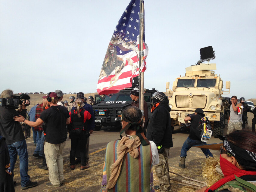 Dakota Access pipeline protesters defy law enforcement officers who are trying to force them from a camp on private land in the path of pipeline construction, Oct. 27, 2016, near Cannon Ball, N.D.  (AP Photo/James MacPherson, File)