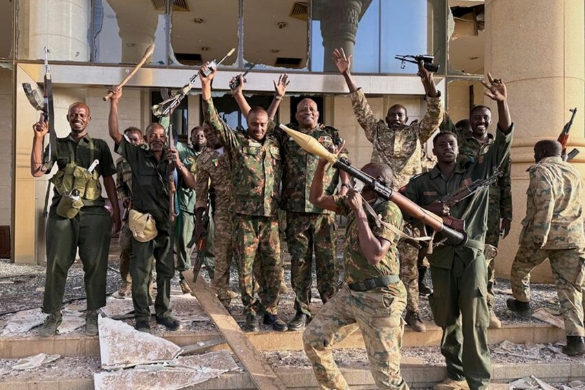 Soldiers celebrate after taking over the Republican Palace in Khartoum, Sudan, Friday March 21, 2025. (SAF via AP )