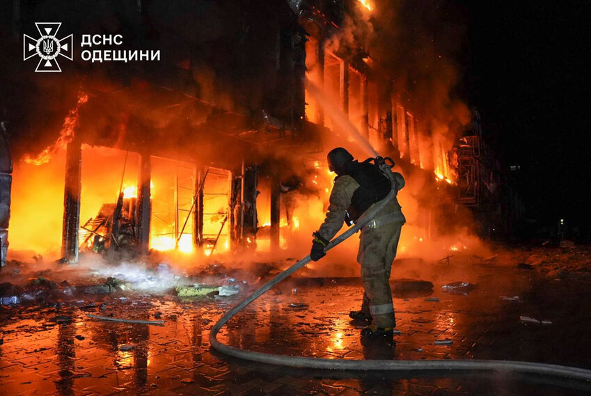 Firefighters put out a fire at a storehouse following a Russian attack in Odesa, Ukraine, Friday, March 21, 2025. (Ukrainian Emergency Service via AP)