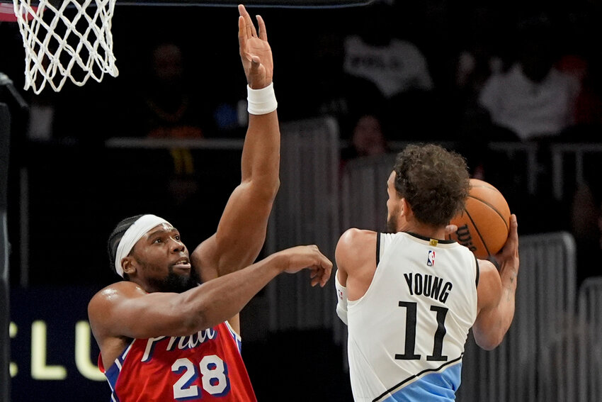 Atlanta Hawks guard Trae Young (11) shoots against Philadelphia 76ers forward Guerschon Yabusele (28) during the first half Sunday, March 23, 2025, in Atlanta. (AP Photo/Mike Stewart)
