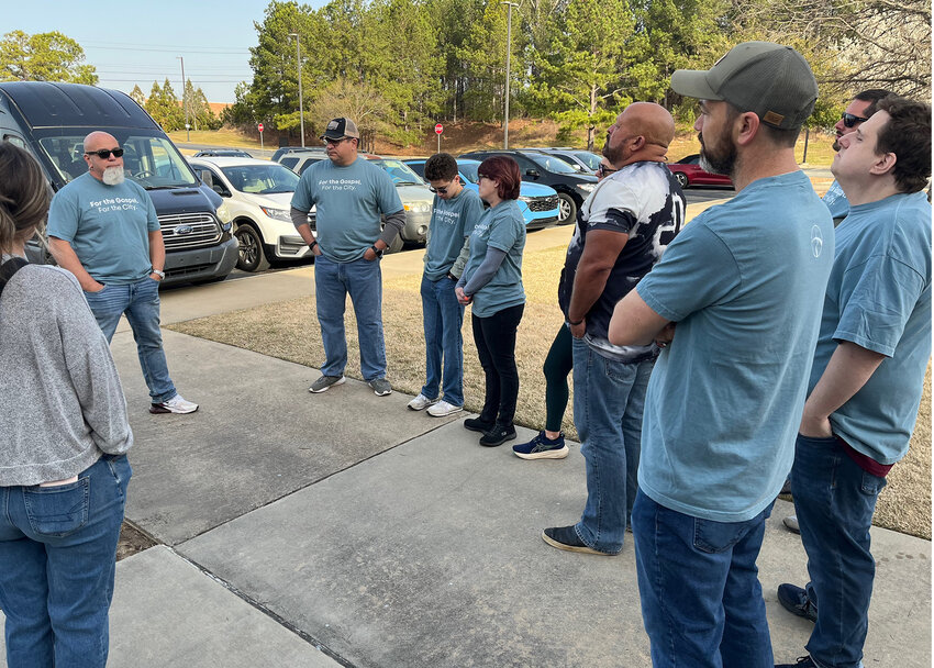 Volunteers from Northway Church pray before heading out to serve their community. (Photo/Northway Church)