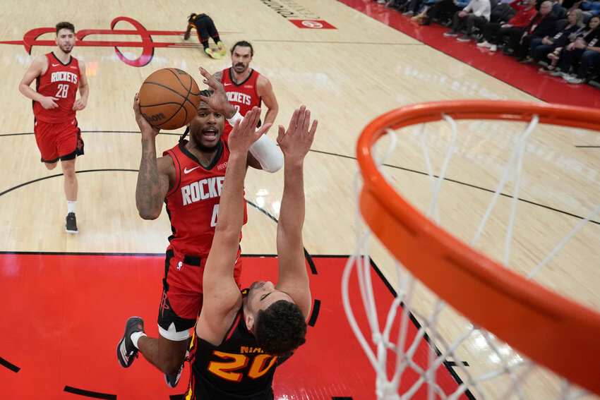 Houston Rockets' Jalen Green shoots over Atlanta Hawks' Georges Niang (20) during the first half Tuesday, March 25, 2025, in Houston. (AP Photo/David J. Phillip)