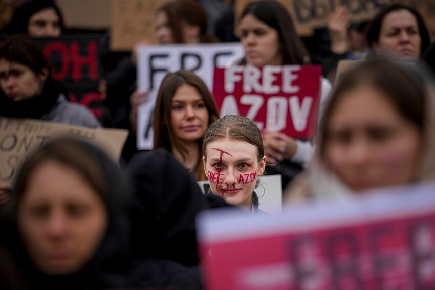 A woman with the words "Free Azov" written on her face attends a rally aiming to raise awareness on the fate of Ukrainian prisoners of war in Kyiv, Ukraine, Sunday, March 24, 2024. (AP Photo/Vadim Ghirda)