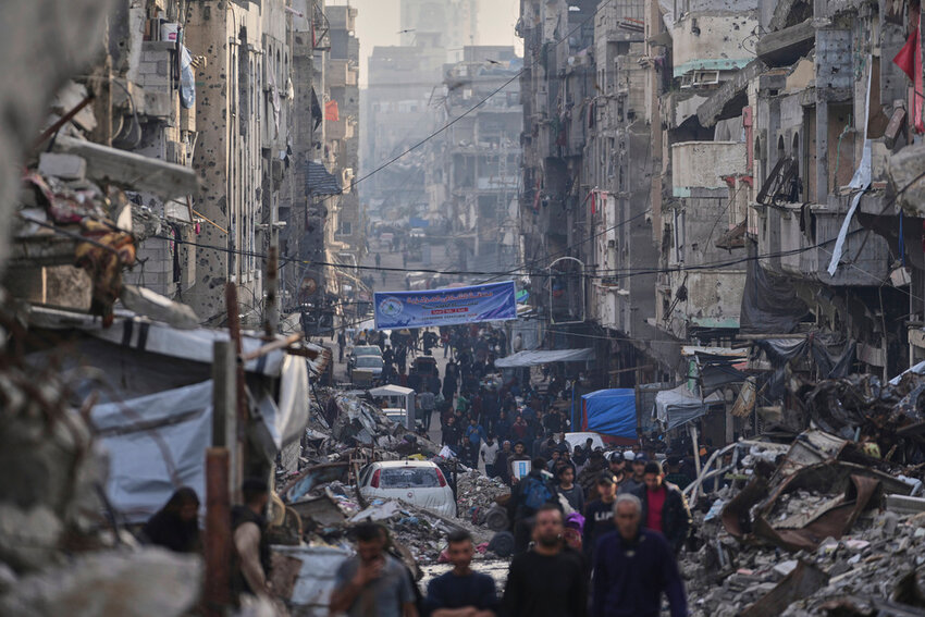 Palestinians walk amid the destruction at Al-Shati camp, Gaza City, Tuesday, March 25, 2025. (AP Photo)
