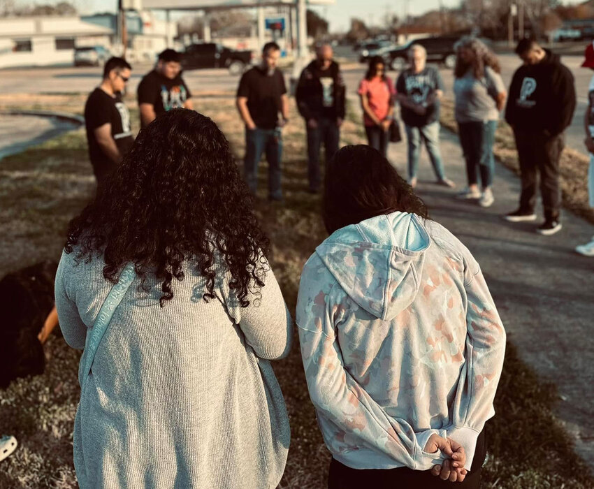 A group of people from Port Arthur City Church pray in public—one of the many ways the congregation is working to make Jesus known in their city. (Photo/Port Arthur City Church via Facebook)