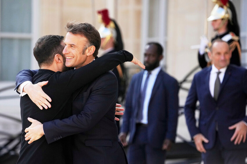 French President Emmanuel Macron greets Ukraine's President Volodymyr Zelenskyy, left, for a summit on Ukraine at the Elysee Palace in Paris, Thursday, March 27, 2025. (AP Photo/Thibault Camus)