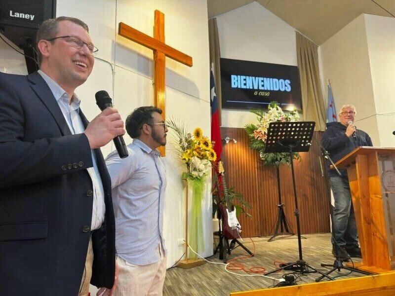 Brad Walker, left, speaks at a Chilean church during a vision tour with 19 Kentucky Baptists earlier this month. (Photo/via Kentucky Today)