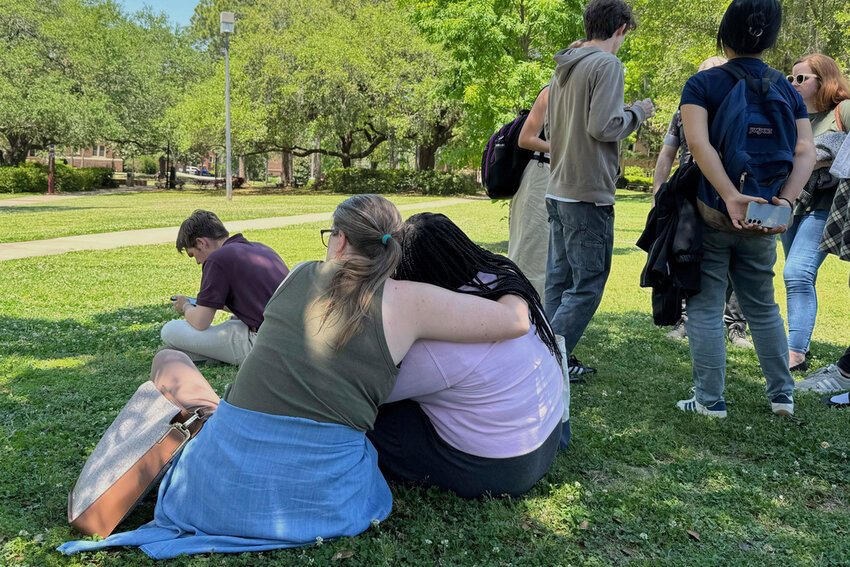 People comfort each other on Florida State University’s campus in Tallahassee, where law enforcement responded to a reported active shooter incident Thursday, April 17, 2025.  (AP Photo/Kate Payne)