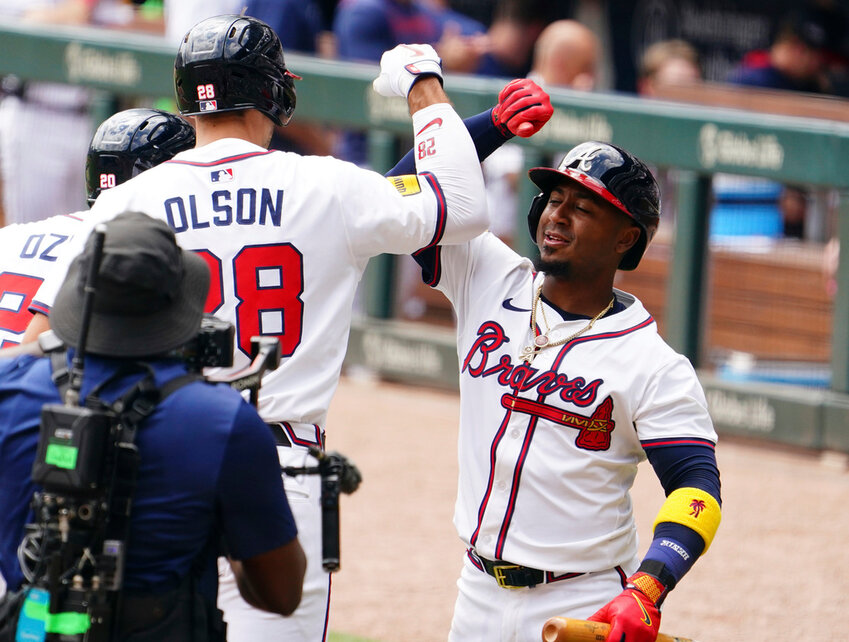Atlanta Braves' Matt Olson (28) celebrates his two-run home run against the Minnesota Twins with teammate Ozzie Albies (1) during the first inning Saturday, April 20, 2025, in Atlanta. (AP Photo/John David Mercer)