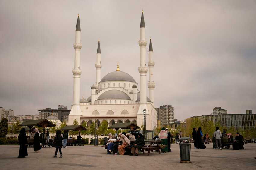 People gather outdoors following an earthquake shock with a preliminary magnitude of 6.2 in Istanbul, Turkey, Wednesday, April 23, 2025. (AP Photo/Khalil Hamra)