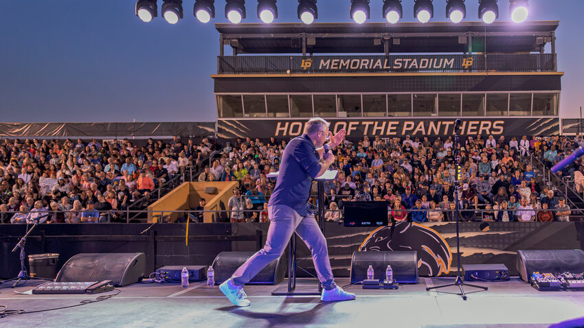 Rick Gage preaches to packed stands at Memorial Stadium in the small Southeast Texas town of Liberty.