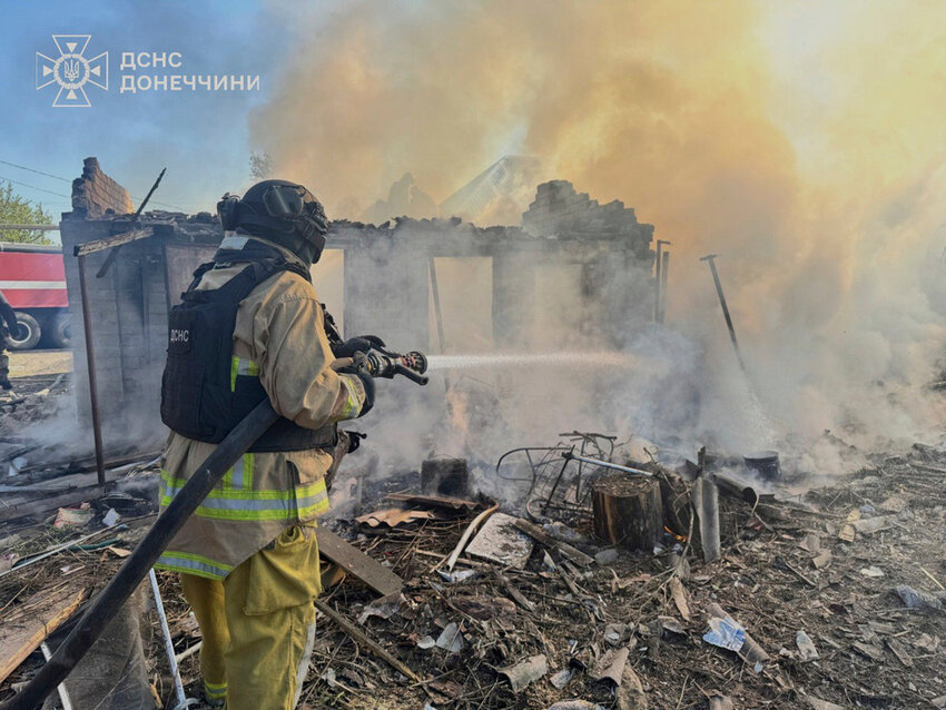 A firefighter puts out a fire at ruined private houses following Russia's air raid in the Donetsk region, Ukraine, Monday, April 28, 2025. (Ukrainian Emergency Service via AP)
