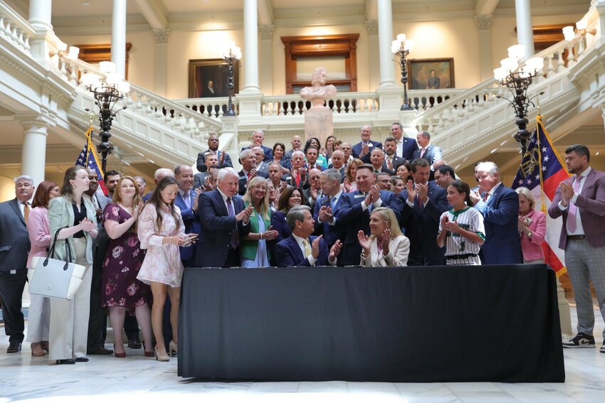 Georgia Gov. Brian Kemp and First Lady Marty Kemp applaud after the governor signed a bill to protect women's sports in the state, Monday, April 28, 2025, at the State Capitol in Atlanta. (Photo/Governor's Office)