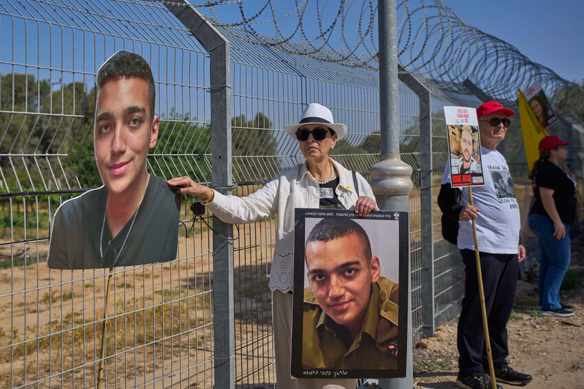 Varda Ben Baruch holds a picture of her grandson Edan Alexander, who is held hostage in Gaza, near the Gaza border in Kibbutz Nir Oz, southern Israel, April 20, 2025. (AP Photo/Ohad Zwigenberg, File)