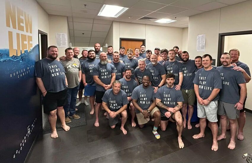 Sixteen men who attended a retreat with North Monroe Baptist Church stepped forward for baptism during a morning worship service at the church. (Photo/via The Baptist Message)