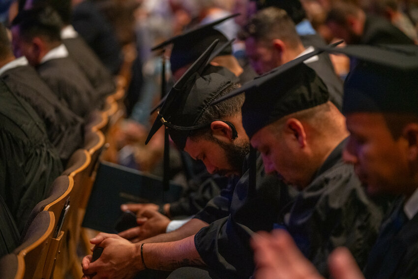 Gateway Seminary graduates pray during commencement May 2, 2025. (Photo/Gateway Seminary)