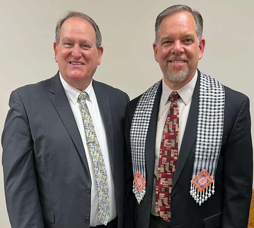 Leo Endel, retiring executive director of the Minnesota-Wisconsin Baptist Convention, stands beside newly named executive director Trey Turner, right.  Turner wears a stole presented to him by Tia Underbakke, who was elected M-W Woman’s Missionary Union executive director during the same meeting. (Photo/MWBC)