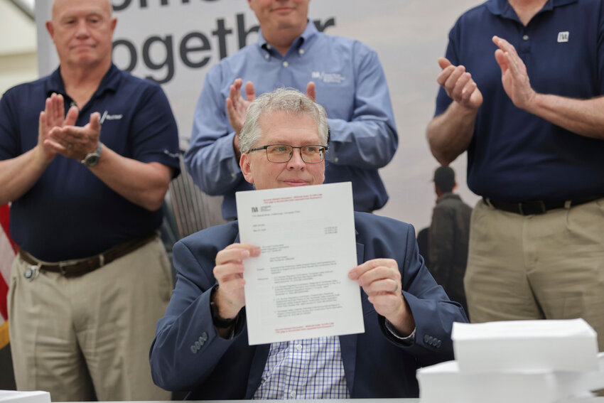 Scott Hunnewell, vice president of the utility’s New Nuclear Program, signs the construction permit application to build a small modular reactor, Monday, May 19, 2025, in Chattanooga, Tenn. (Tennessee Valley Authority via AP)