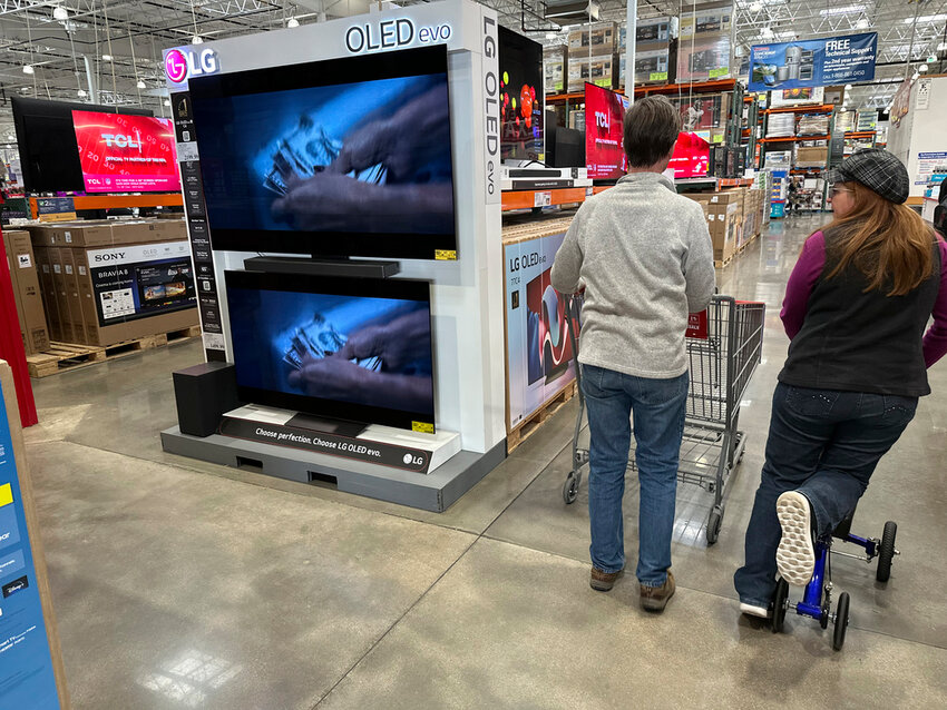 Shoppers pass large-screen televisions on display in a Costco warehouse in Colorado Springs, Colo., Dec. 19, 2024 (AP Photo/David Zalubowski, File)