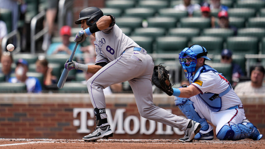 Colorado Rockies' Ryan Ritter bunts against the Atlanta Braves in the third inning Sunday, June 15, 2025, in Atlanta. (AP Photo/Mike Stewart)