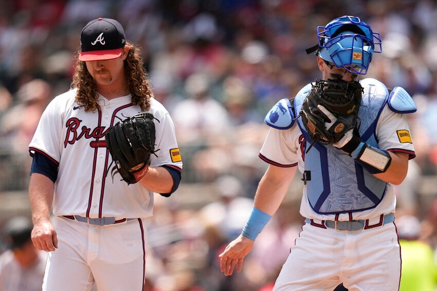 Atlanta Braves pitcher Grant Holmes, left, speaks with catcher Sean Murphy in the sixth inning against the Colorado Rockies, Sunday, June 15, 2025, in Atlanta. (AP Photo/Mike Stewart)