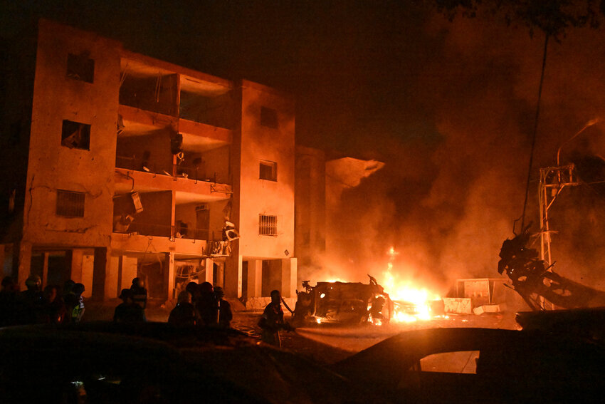 Firefighters work to extinguish a blaze after a missile launched from Iran struck Haifa, in northern Israel, on Sunday, June 15, 2025. (AP Photo/Rami Shlush)