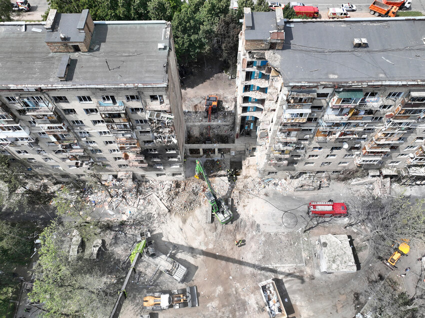 Searchers sift through the wreckage at the site of a Tuesday's deadly Russian missile attack that ruined a multistory residential building in Kyiv, Ukraine, Wednesday, June 18, 2025. (Ukrainian Emergency Service via AP)