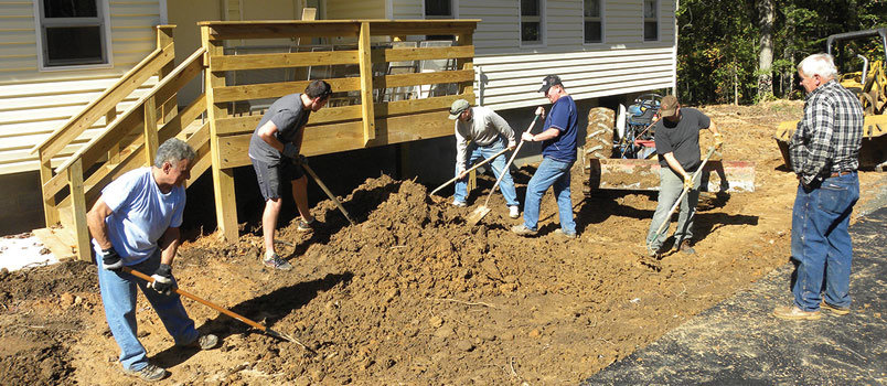 A volunteer force of Dahlonega-area workers, these doing landscaping, have invested hundreds of hours of time to refurbish duplexes donated by the University of North Georgia. GERALD HARRIS/Index