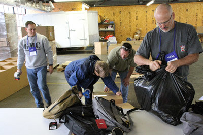 In this file photo, left to right, Baptist Collegiate Ministries directors David Kirkland (Georgia College and State University), Penny Chestnut (ABAC), Tony Branham (Armstrong Atlanta State University and Coastal College of Georgia), and Nathan Byrd (UGA) prepare to ship backpacks collected by Georgia Baptists for Appalachian schoolchildren. GBC COMMUNICATIONS/Special