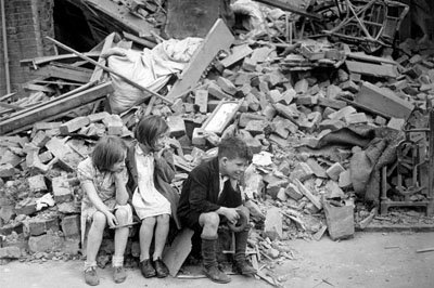 Children in east London sit among rubble after bombing by the Nazis. NEW TIMES PARIS BUREAU COLLECTION/