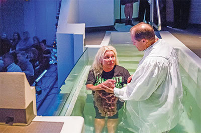 Former adult dance club owner Teresa Fears arrives at the moment of her baptism by Gregg Zackary, associate pastor of Mobberly Baptist Church in Longview, Texas. Photo by Alyssa Rummel