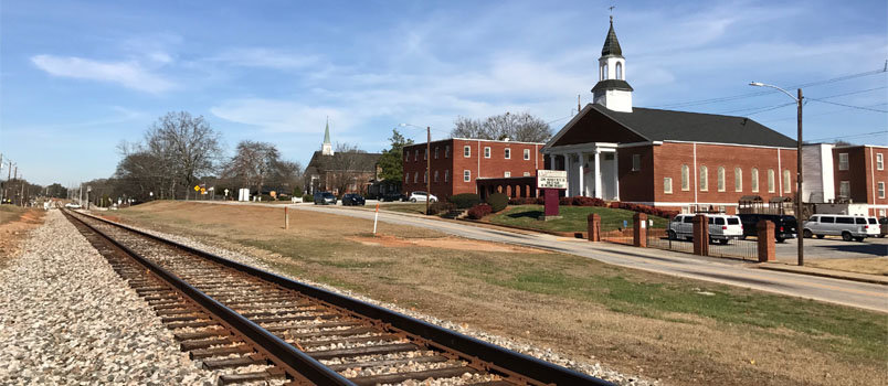 Clarkson's railroad tracks dividing the town may be representative of the national debate on immigration dividing the nation, but the town  remains firmly united about helping the new Americans in their midst. Clarkson International Bible Church is shown at the right. JOE WESTBURY?Index