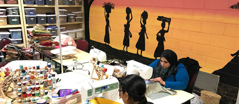 The Refugee Sewing Society allows women to sew or mend their own clothes or make items for sale in their store at Clarkston International Bible Church. Many of the women and their family members escaped death by fleeing their native lands.  JOE WESTBURY/Index