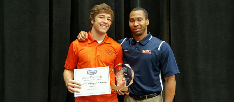 Brenton-Parker Head Wrestling Coach Tim Mitchem, right, says Nate Pristavec "is a leader, the kind of guy every team wants." Pristavec is holding an award as East Region Wrestler of the Year (similar to MVP) for a tournament at Life University in Marietta, where he also received the Championship of Character Award.  BPC/Special