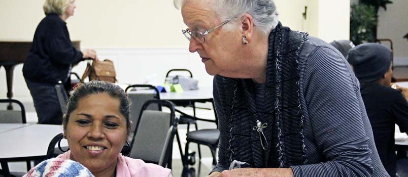 Literacy ministry volunteer Anne Parks, right, uses objects in her English-as-a-Second Language (ESL) lesson plans. During a meeting of the literacy ministry of Grady County Baptist Association, the female students made clothing items. SUE HENSON/Special