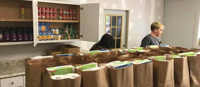 Bryson Arthur, a student at Faceville Baptist, helps put together bags for the church's monthly food bank. Community outreach has become a hallmark of the church located just north of the Florida state line. FACEVILLE BC/Special