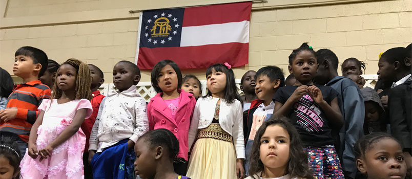 Children of immigrants and refugees from around the world sing at a worship service at Clarkston International Bible Church earlier this year. The children, with the Georgia state flag behind them, are the new face not only of the state but the nation as minority populations eclipse Anglos in the state and nation.  JOE WESTBURY/Index
