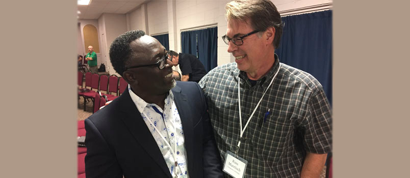 At right Russ Muretisch, minister of music and discipleship at Crosspointe Community Church in Roswell, and E. Moses Ashun, from Ghana and pastor of the multicultural Life Chapel in Lawrenceville, enjoy getting to know each other. GERALD HARRIS/Index