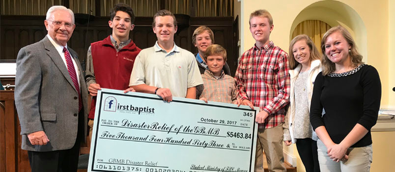 Bobby Boswell, assistant executive director of the Georgia Baptist Mission Board, receives a check for Disaster Relief from students of First Baptist Church Monroe. Pictured left to right after Boswell are: Sam Eckles, Jack Ellerbee, Colin Phelps, Albert Brown, Noah Prather, Sarah Beth Brown, and Gloria Briscoe, assistant student minister. FB MONROE/Special