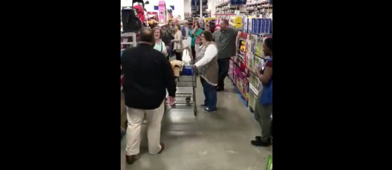 Slade Alday, in black shirt, is joined by others at a Dothan, AL Sam's Club singing "Our God is Awesome" in a video seen by more than 7 million on Facebook. At right is a Sam's Club employee who joined in, Christian Melton. MICHELLE HOLLAND CONNER/Facebook