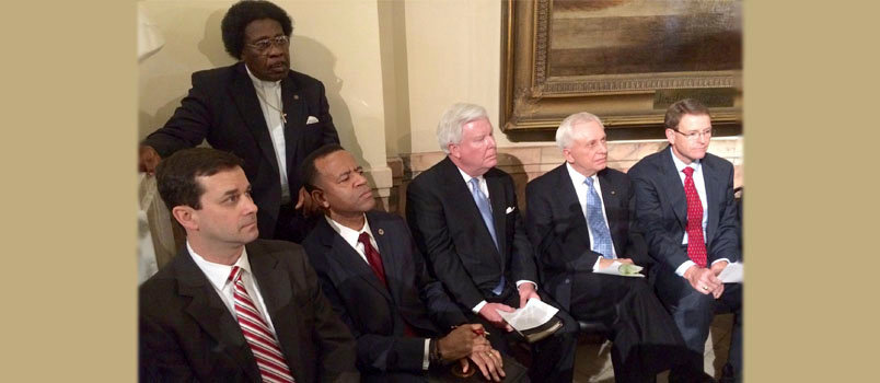 Former Atlanta Fire Chief Kelvin Cochran, second from left, sits with supporters including, beginning to the right of Cochran, J. Robert White; Richard Lee, former pastor of Reedeemer Church in Cumming; and Tony Perkins, president of the Research Family Council.
