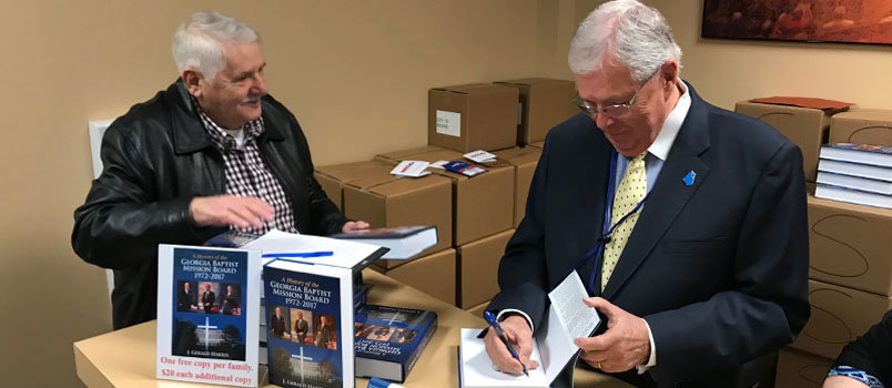 Novel Germany waits as unofficial historian and Index Editor Gerald Harris autographs one of hundreds of books that were given away at the annual Convention meeting in November. JOE WESTBURY/Index