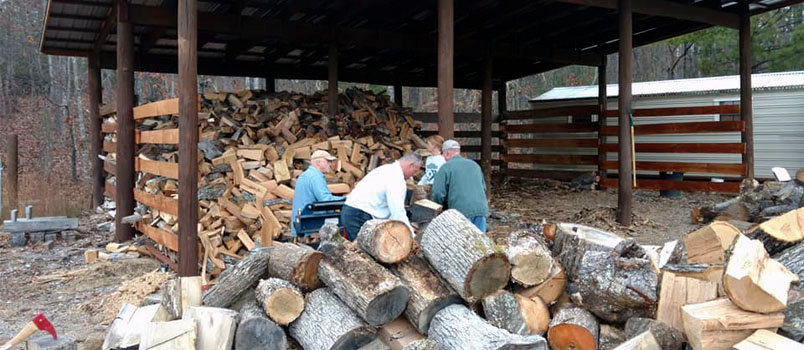 Left to right Steve Reach, Dan Grader, Laura Nightengale, and Larry Davis split and move wood into the "wood corral" at Antioch Baptist Church in Blairsville. The church has provided wood to those in need for the last nine years. DUANE MANDERS/ABC