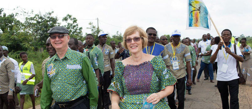 Randy and Kathy Arnett celebrate the 50th anniversary of Baptist work in Cote d'Ivoire in August 2016, walking about two miles to a seminary alongside fellow Christians. The Arnetts, who died March 14, were known for the joy they shared with African friends and colleagues. WILLIAM HAUN/IMB