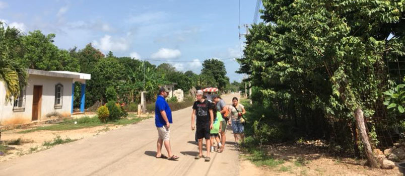 Brewton Parker students Austin Pounds in blue shirt, Jake Vinson in black shirt, and Lydia Clements in grey baseball cap engage in street evangelism on the Yucatan Peninsula.  DBA/Special