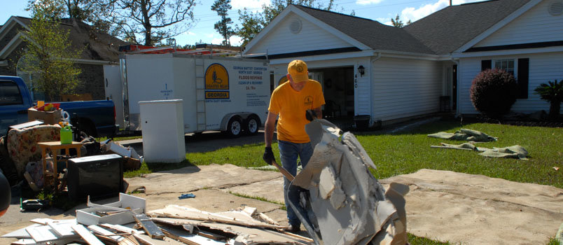 Georgia SBDR volunteer Fort Oglesby, of First Hartwell, hauls debris to the street from a flood damaged home in Longs, SC. He worked with 6 others to help homeowner Ray Childers, 71, who has lived in his home for 20 years in the Aberdeen Golf Community. Childers’ wife is in a nursing home and he is staying with his daughter. Almost all of the homes in the community and took on several feet of water. LAURA SIKES/NAMB