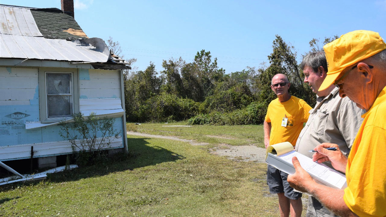 Tom Hale of Apex, North Carolina (left) and James Davis of Chapel Hill, North Carolina (right) assess Hurricane Dorian damage to Randall Styron's house on Cedar Island. North Carolina Baptists on Mission are at work in Cedar Island and the town of Atlantic, North Carolina, after the storm. SAM PORTER/NAMB