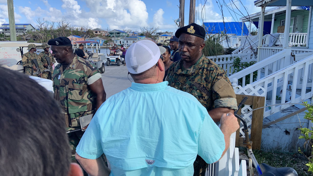 Eric Rentz, back to camera, is greeted by a member of the Bahamian Defense Force on the island of Green Turtle Cay in the Bahamas Oct. 4. Rentz, Georgia Baptist Missions consultant for the  state's Southeast Region, accompanied a group that included two associational missionaries to help map out ways Georgia Baptists can assist with ongoing reconstruction efforts after Hurricane Dorian. JON GRAHAM/Special