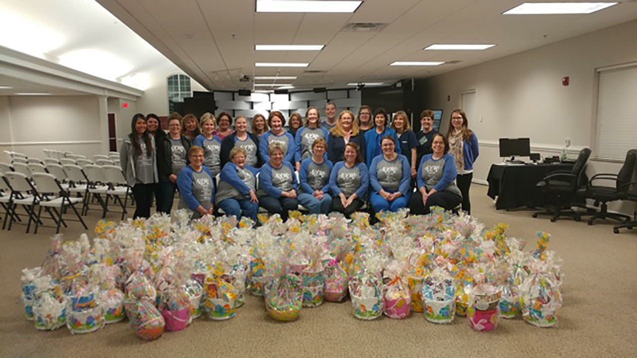 Members of the Women's mission group with the 160 Easter baskets given to a primary school. BBBC/Special